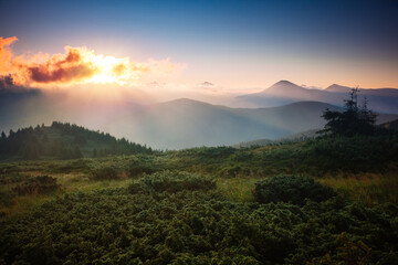 Poster - A breathtaking view of the mountain ranges illuminated by the sun's rays.