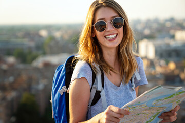 Wall Mural - young woman, student traveler with backpack enjoying summer vacation.