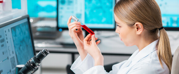 Wall Mural - Professional female scientist is working on a vaccine in a modern scientific research laboratory. Laboratory tools: microscope, test tubes, equipment. Future technology, healthcare and science.