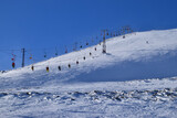 Fototapeta Kwiaty - Panorama of the cable car with skiers on Mount Cheget