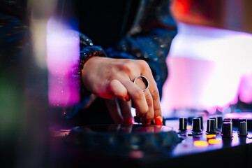 Wall Mural - woman DJ Hands creating and regulating music on dj console mixer in concert