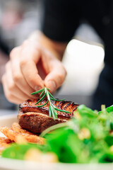 Sticker - chef hand cooking Roasted Duck breast fillets with vegetable salad and batat in plate on restaurant kitchen