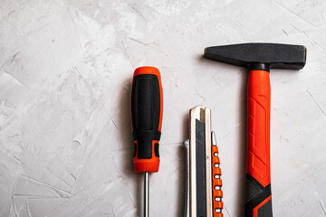 Wall Mural - Top view of working tools, hammer, screwdriver, pliers, electric drill, tape measure, screws on a white background.