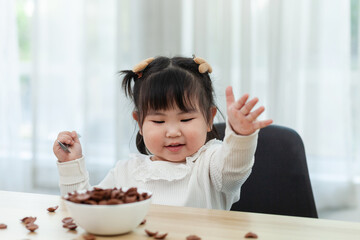 Young Asian children enjoying breakfast on the dining table. Enjoy breakfast.