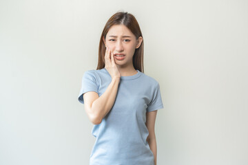 Wall Mural - Face expression suffering from sensitive teeth and cold, asian young woman, girl feeling hurt, pain touching cheek, mouth with hand. Toothache molar tooth, dental problem isolated on white background.