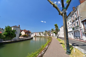 Wall Mural - France, Montargis. Cityscape with a canal. May 29, 2023.