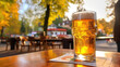 © paffy - Oktoberfest banner. Beer Jar on wooden table in open air cafe or pub, blured autumn town on background. AI generative