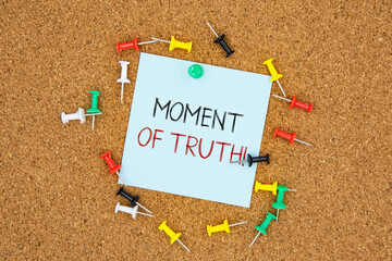 Poster - Moment of truth text on light blue post-it paper pinned on bulletin cork board surrounding by multi color pins. This message can be used in business concept about moment of truth.