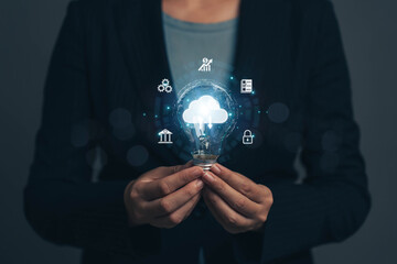 Poster - Businessman holding a light bulb. The concept of generating ideas at work. New ideas. Ideas for managing financial systems and online marketing with cloud technology to link data online