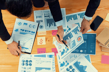 Poster - Top view analyst team discussing financial data on digital dashboard, analyzing chart and graph papers by data science software on wooden table background. Business intelligence and Fintech. Fervent