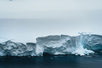 Wall Mural - A floating iceberg in the antarctic peninsula, antarctica and arctic greenland. Global warming and Climate chance concept. Iceberg with hole.