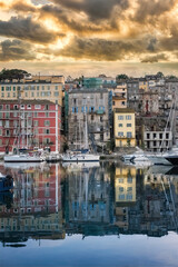 Wall Mural - Corsica, Bastia, typical houses in the harbor in summer, sunset
