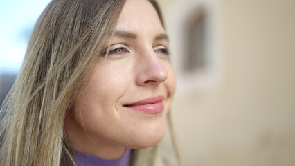 Sticker - Young blonde woman smiling confident looking to the side at street