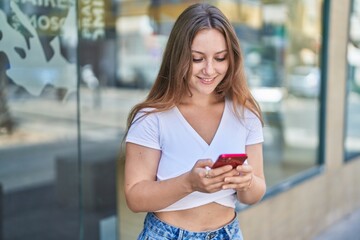 Sticker - Young blonde woman smiling confident using smartphone at street