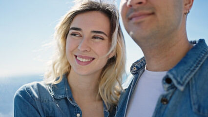 Canvas Print - Man and woman couple smiling confident standing together at seaside