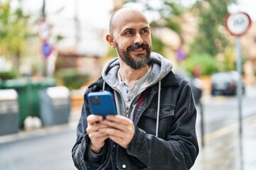 Poster - Young bald man smiling confident using smartphone at street