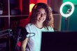 © Krakenimages.com - Young beautiful hispanic woman streamer playing video game using computer at gaming room