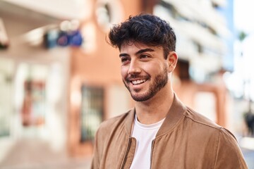 Poster - Young hispanic man smiling confident looking to the side at street