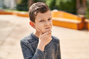 Poster - Blond child standing with doubt expression at park