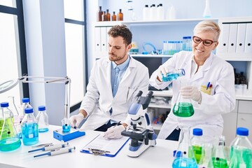 Sticker - Mother and son scientist partners measuring liquid at laboratory