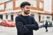 © Krakenimages.com - Young arab man smiling confident standing with arms crossed gesture at street