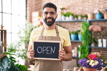 Sticker - Hispanic man with beard working at florist holding open sign smiling with a happy and cool smile on face. showing teeth.