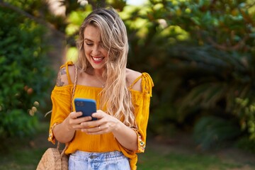 Sticker - Young woman smiling confident using smartphone at park