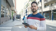© Krakenimages.com - Young latin man smiling confident using touchpad at street