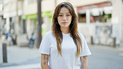 Sticker - Young beautiful hispanic woman standing with serious expression at street