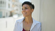 © Krakenimages.com - Young beautiful hispanic woman smiling confident looking to the side at street