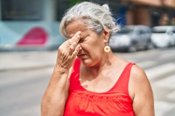 Poster - Middle age grey-haired woman stressed standing at street