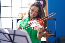 Young Hispanic Woman Musician Smiling Confident Playing Violin At Music Studio