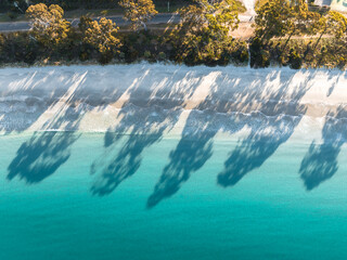Wall Mural - drone birdseye view of adventure bay, tasmania, australia. blue water with shadows during sunset. be