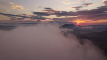 Wall Mural - flying above the clouds. aerial view of clouds and sunset sun. traveling by air perfect background, 