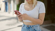 © Krakenimages.com - Young beautiful hispanic woman using smartphone at street