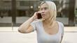 © Krakenimages.com - Young beautiful hispanic woman talking on smartphone with serious expression at street