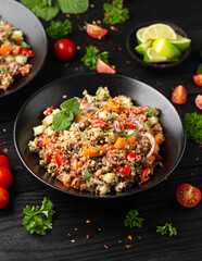 Wall Mural - Red and white quinoa tabbouleh salad with tomatoes, paprika and mint. Vegetarian, vegan food concept