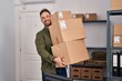© Krakenimages.com - Young caucasian man ecommerce business worker holding packages at office