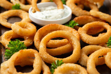 Wall Mural - Crunchy Fried Battered onion rings with garlic sauce