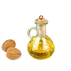 Wall Mural - Walnut oil in a bottle and walnut fruit isolated on white .