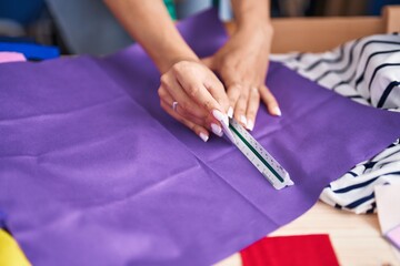 Sticker - Young caucasian woman tailor cutting cloth at street