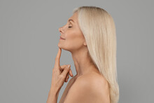 Anti-Aging Skincare. Beautiful Mature Female With Flawless Skin Touching Chin, Side View