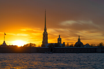 Wall Mural - The ancient Peter and Paul Cathedral against the background of the gloomy May sunset. Saint Petersburg, Russia