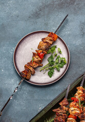 Wall Mural - Bbq grilled meat pork and vegetable skewers on gray plate . Top view, flat lay, gray background