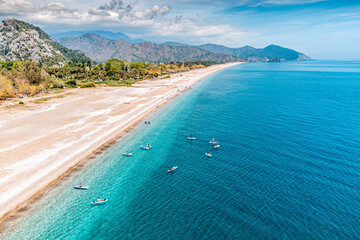 Wall Mural - Aerial view of a Cirali beach in Turkey with group of sup boarders swimming in the sea. Paradise resort and vacation