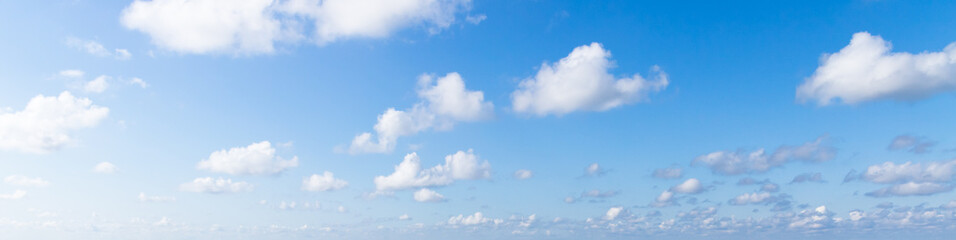 Wall Mural - blue sky with white cumulus clouds on a sunny day. natural panorama