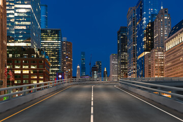 Empty urban asphalt road exterior with city buildings background. New modern highway concrete construction. Concept of way to success. Transportation logistic industry fast delivery. Chicago. USA.