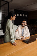 © Drobot Dean - Two indian colleagues using laptop and tablet while working together in office