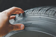 Leinwandbild Motiv Closeup of the tread of a summer car tire on a sunny day. tires against black. fuel efficient car tires.