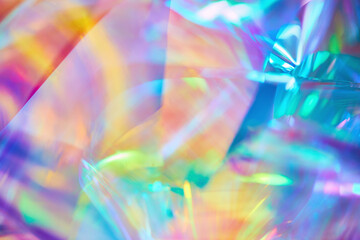 Poster - Close-up of ethereal bright neon pink, magenta, orange, blue, purple holographic metallic foil background. Abstract modern curved blurred surreal futuristic disco, rave, techno, festive backdrop